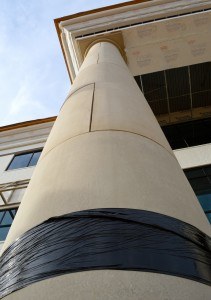 A view up one of the four large main columns at the front entrance of the Arkansas College of Osteopathic Medicine.