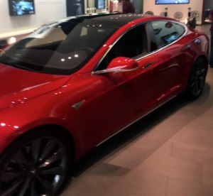 A four-door Tesla Model S sits on the small showroom floor at the Tesla store in Dallas.