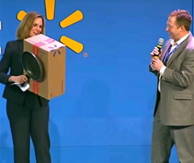 Laura Phillips, vice president of sustainability for Walmart U.S., demonstrates the how the retailer is doing a better job using smaller boxes for online orders after customers brought this to the company’s attention last year. The box in this picture was the box used prior to changing to a smaller box that better fit the product and kept it safe during shipping.