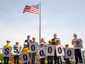 Children help J.B. Hunt execs unveil the company’s $5 million gift to the Arkansas Children’s Hospital.