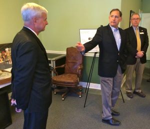 U.S. Sen. John Boozman, R-Ark. (center), gestures toward U.S. Rep. Steve Womack, R-Rogers (left), during a check presentation at the U.S. Marshals Museum office in downtown Fort Smith on May 7. Pictured at right is Jim Dunn, outgoing president and CEO of the U.S. Marshals Museum.