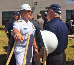 Capt. Scott Pappano, the Strategic and Attack Submarine Program Manager for the U.S. Navy, visits with a guest following a ceremonial groundbreaking at Exide’s Fort Smith plant.