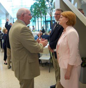 Kyle Parker (left), president and CEO of the Arkansas Colleges of Health Education, visits with Dr. Robin Bowen, president of Arkansas Tech University (right), and Bruce Sikes, chancellor of Arkansas Tech University-Ozark Campus.