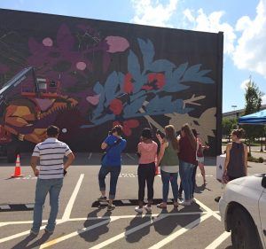 Future School of Fort Smith students watch mural artists Jaz and Pastel.